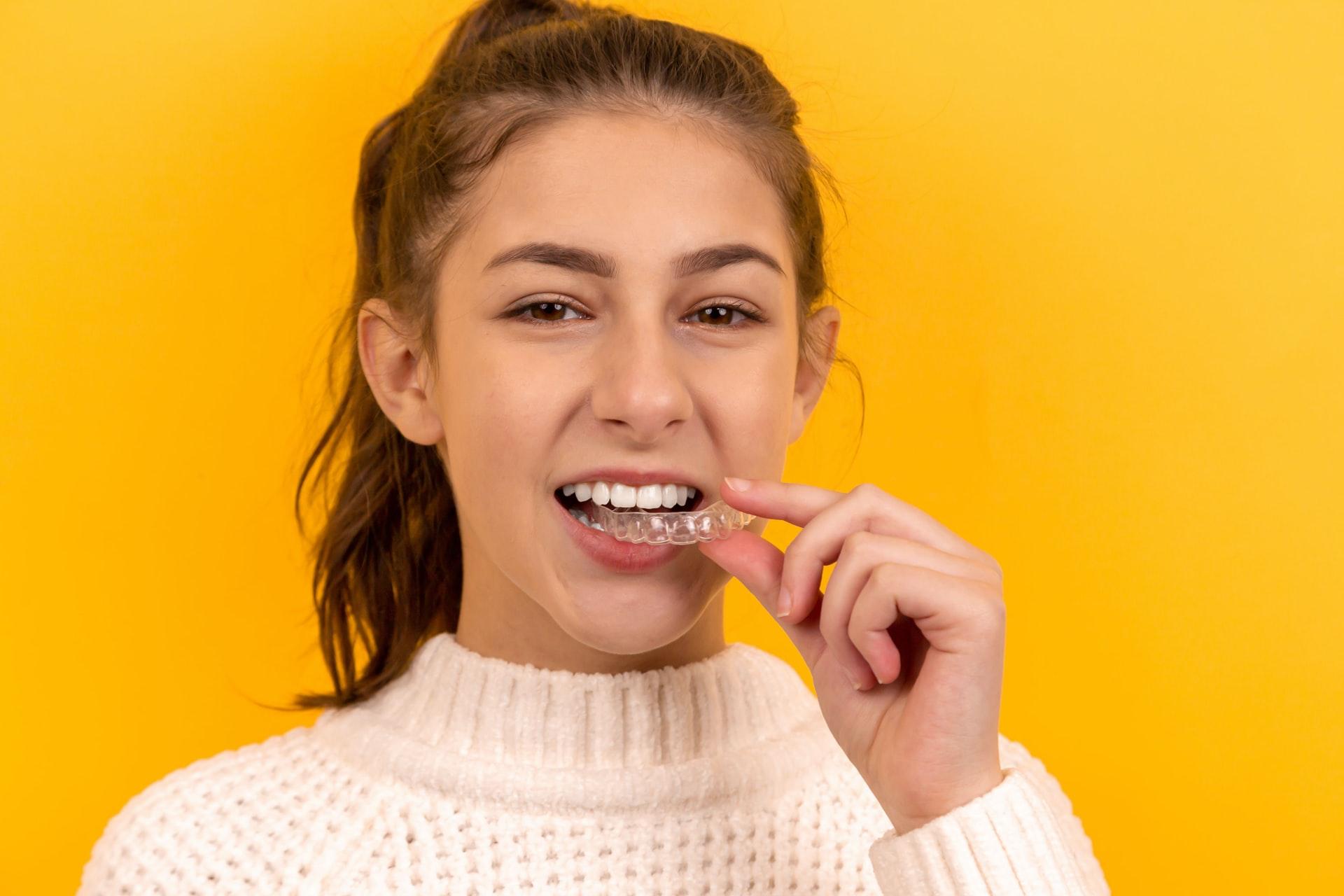 girl using a clear aligner