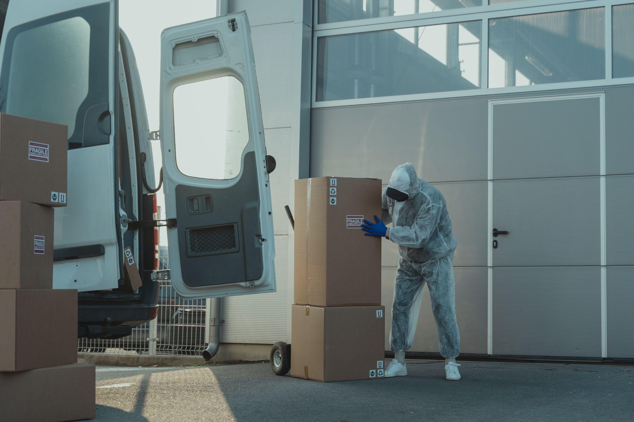 Man wearing PPE while loading cargo 