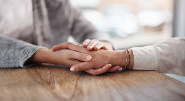 You care and support changes everything Closeup shot of two unrecognisable people holding hands in comfort empathy stock pictures, royalty-free photos & images